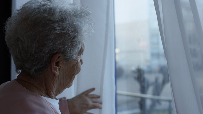 elderly woman looking out the window