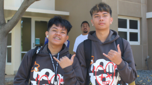 Two students flashing shaka