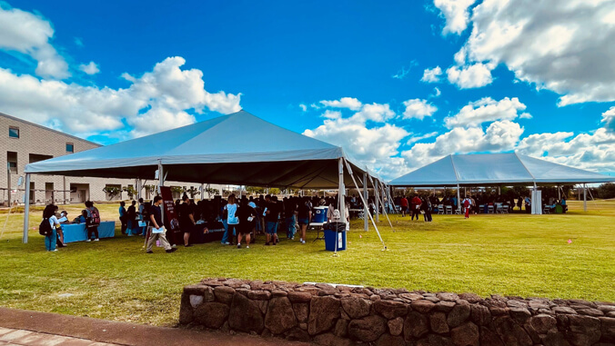 Tents with students and employers on the lawn at U H West Oahu