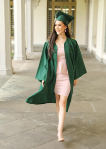 person smiling with a cap and gown