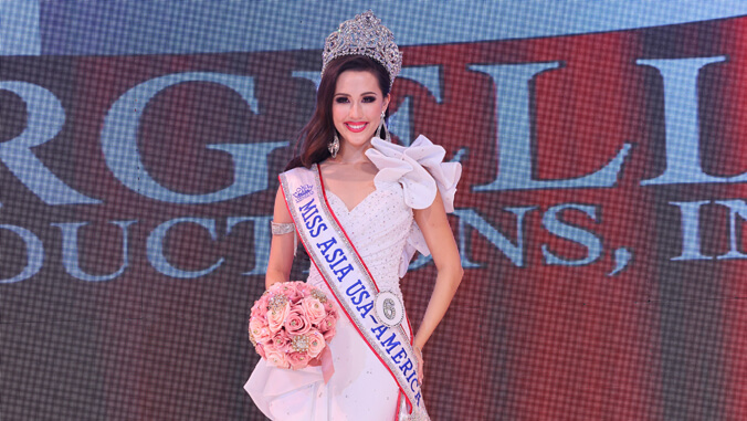 person in a crown gown and sash