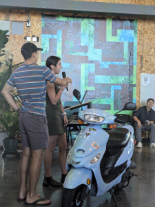 Kai Garcia and Andrea Martinez presenting their project with a Moped