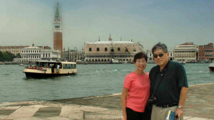 two people standing in front of a river