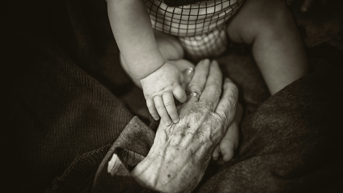 person holding hands with a baby