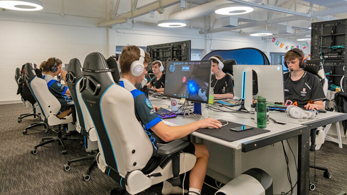 people sitting in front of computers playing games