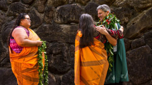 Lassner with two people with lei