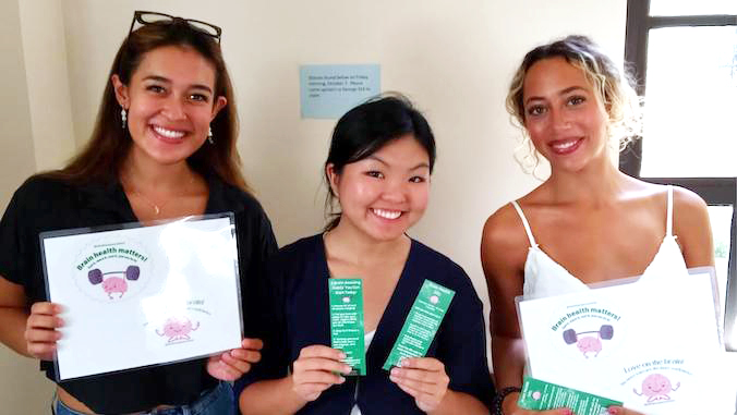 three students smiling