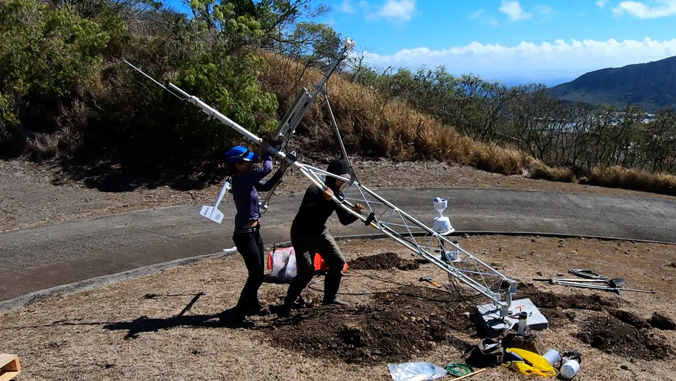 people installing weather instruments