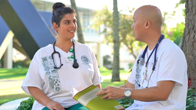 two people in uniform sitting on a bench