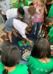 students looking at lego demonstration