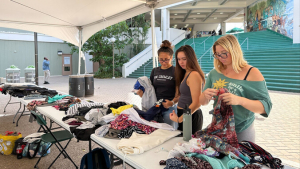 students looking through clothing at the clothing swap