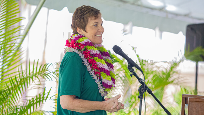 person speaking in front of a microphone