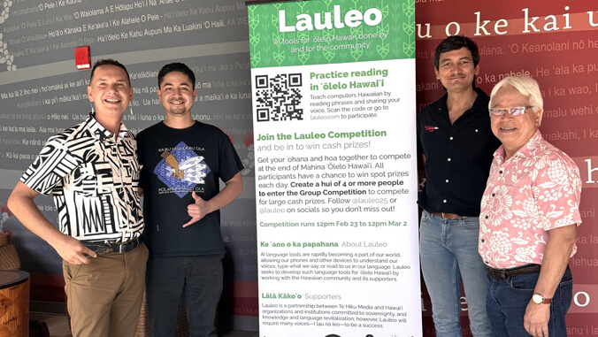 People smiling near a Lauleo sign