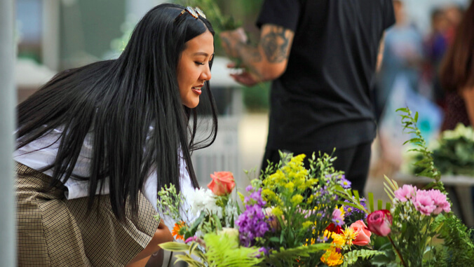 girl looking at flowers