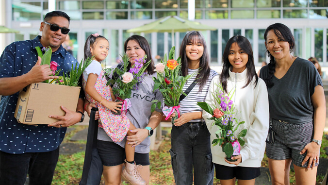 people holding flowers arrangements