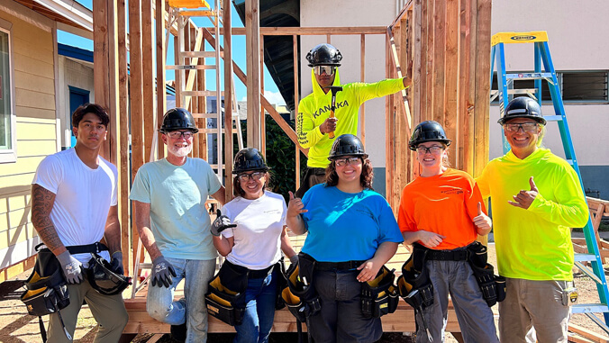 Smiling people in front of construction project