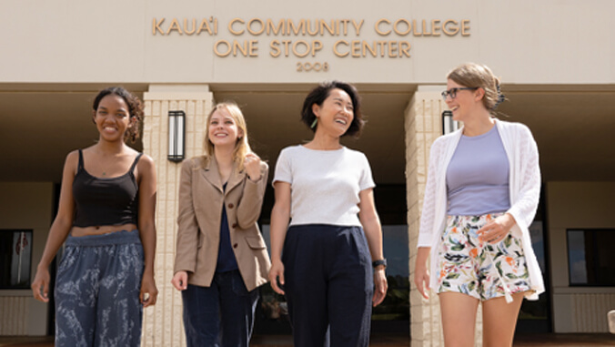 Four students walking outside