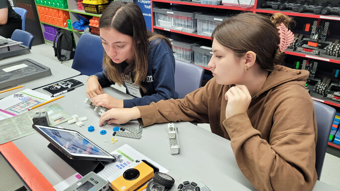 2 students looking a tablet 