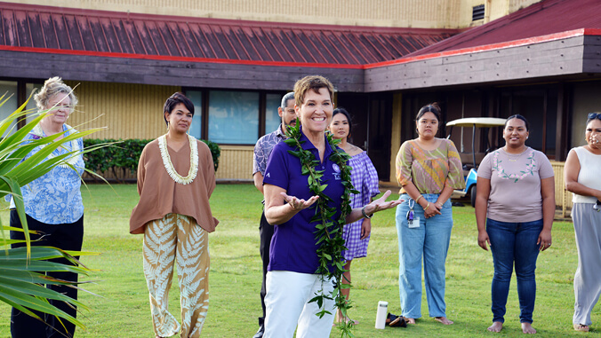 Hensel standing outside with people behind her