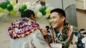 Two people wearing lei