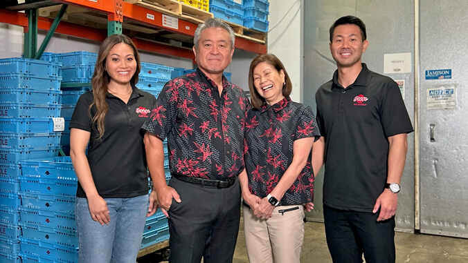 four people standing in a warehouse