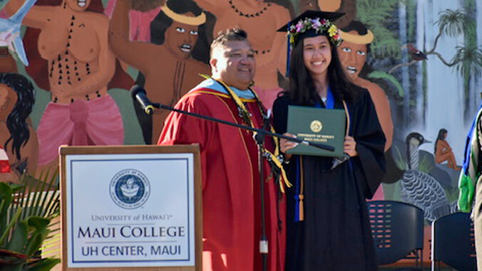 Rodrigues getting diploma from Chancellor Hokoana