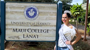 Rodrigues in front of U H Maui College sign