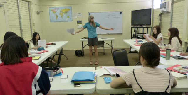 photo of classroom with teacher, students